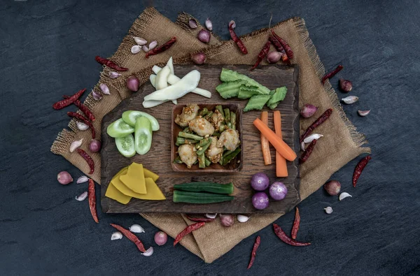 タイ料理赤カレーと魚のボールを炒め木の背景に具材と新鮮な野菜と長い豆を貼り付けます — ストック写真