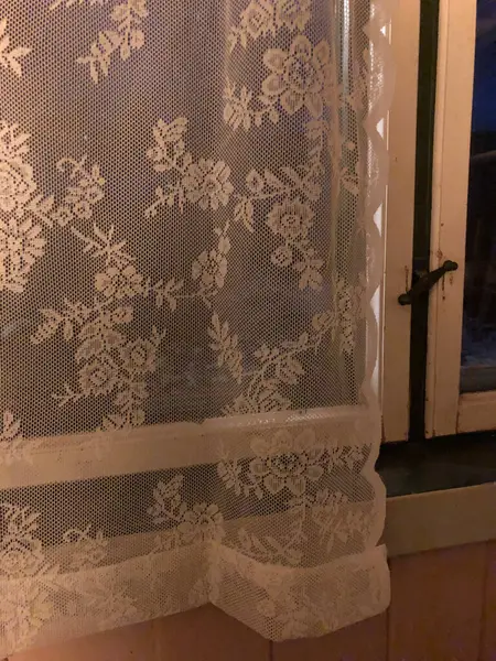 Old lace curtains in window