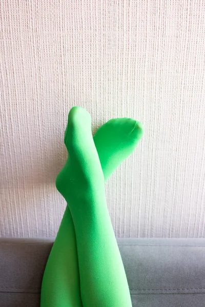 Ноги Вверх Зелеными Колготками Покоится Стене Диване — стоковое фото