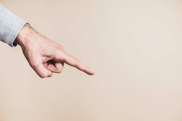 stock image Male hand pointing on beige background