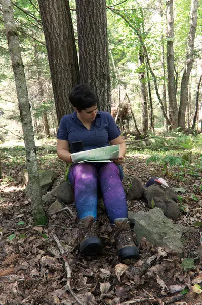 woman  reading map in the forest  on nature background