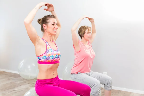 Two Women Performing Yoga Exercise — Foto Stock