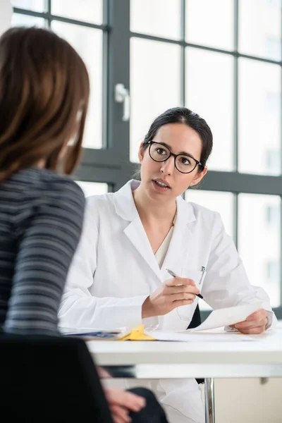 Female physician listening to her patient during consultation in the office of a medical center