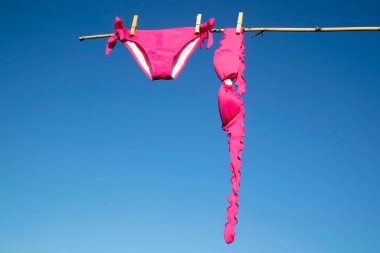 Güneşte kurutmak için renkli kadın mayosu.