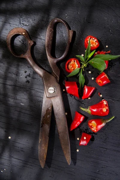 Stock image close-up view of red pepper slices and vintage scissors 