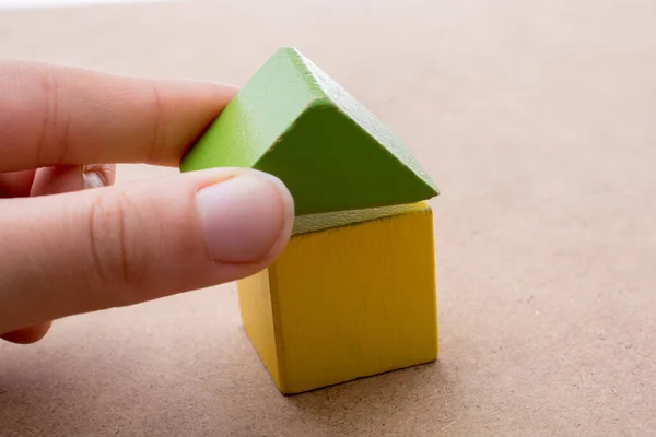 Hand Holding House Formed Out Building Blocks — Stock Photo, Image