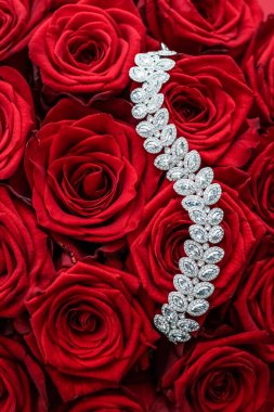 Luxury diamond bracelet and bouquet of red roses, jewelry love gift on Valentines Day and romantic holidays present