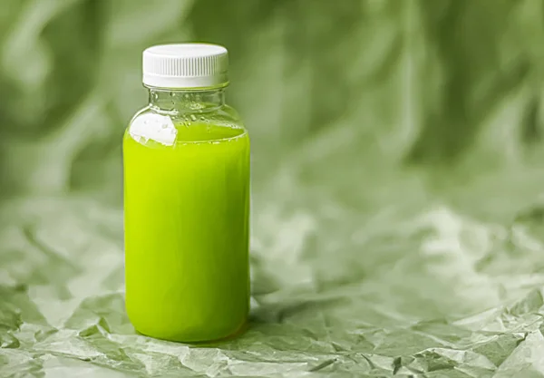Fresh green juice in eco-friendly recyclable plastic bottle and packaging, healthy drink and food product
