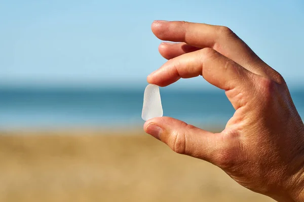 Person Holds Single Piece White Sea Glass Finger Thumb — стоковое фото