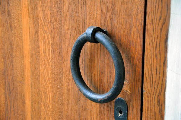 Heavy wooden doors brown. Ring shaped handle