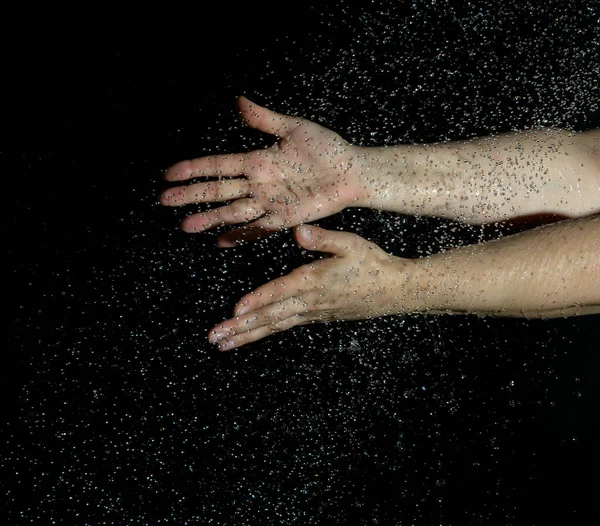 Two Female Hands Flying Drops Water Black Background — Stockfoto