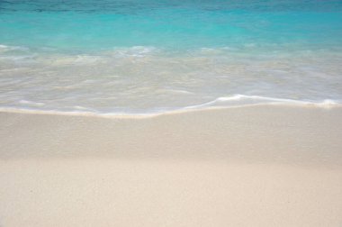 Deniz suyu olan beyaz kumsal.