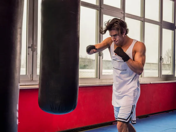 Muscular Sportive Man Training Punching Bag While Boxing — Stock Photo, Image