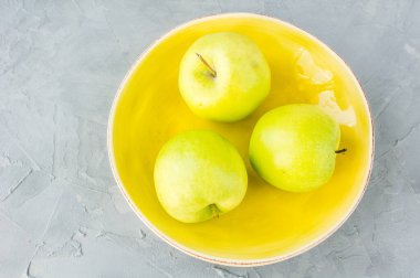 close-up shot of fresh organic green apples on tabletop for background