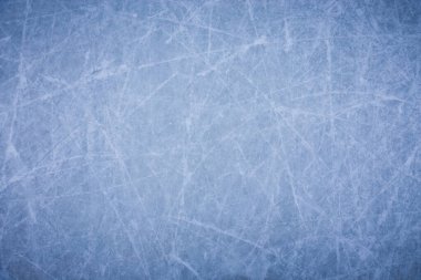 Ice background with marks from skating and hockey, blue texture of rink surface with many scratches