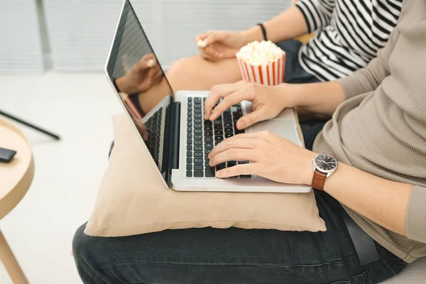 stock image Young asian couple payment online using laptop buying movie ticket