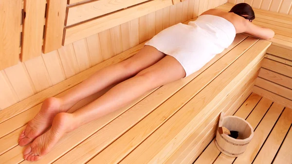 Woman Relaxing Wooden Sauna Lying Her Belly Bench Towel Wrapped — Stock Photo, Image
