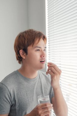 Man With Fish Oil Capsules.