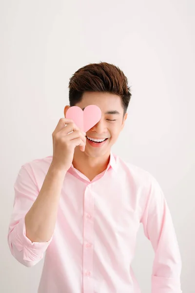 Handsome Asian Man Holding Pink Heart Paper Posing Gray Background — ストック写真