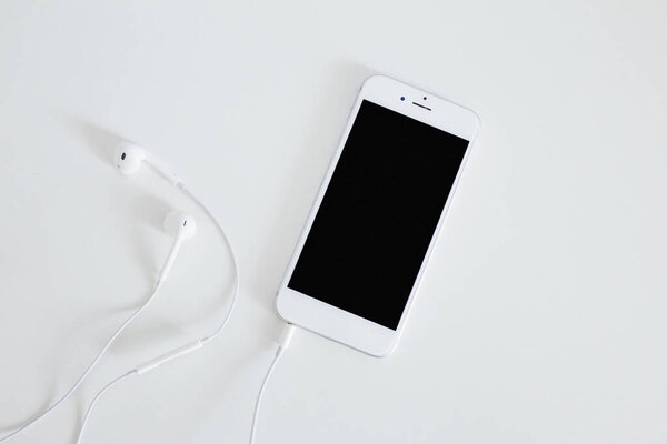 smartphone with earphone isolated white background. High quality beautiful photo concept