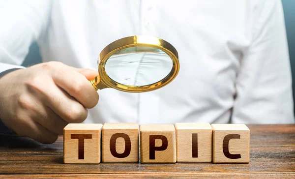 Man Examines Blocks Topic Magnifying Glass Conduct Research Get Topic — Stock Photo, Image