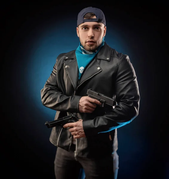 stock image guy in a leather jacket with a shotgun