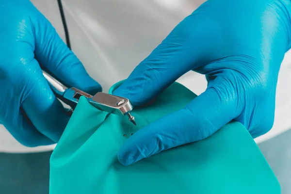 Dental procedure, installation of a cofferdam to the patient, modern treatment, preparation for installation.
