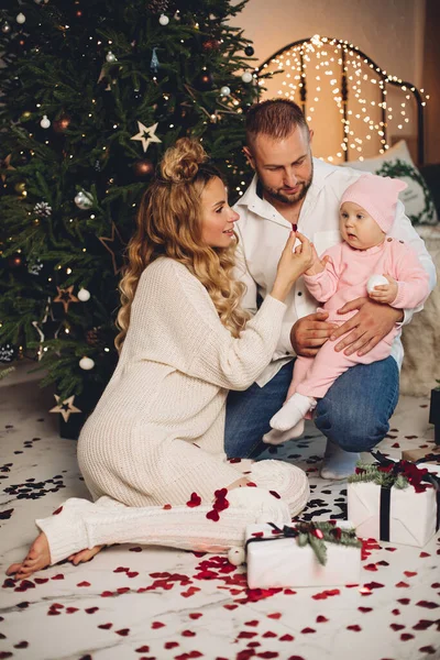 stock image Mother and father with baby daughter at xmas.