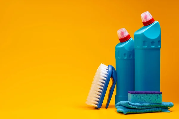 stock image House cleaning detergent bottles on a yellow background