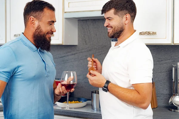 stock image Happy homosexual couple preparing food together in kitchen