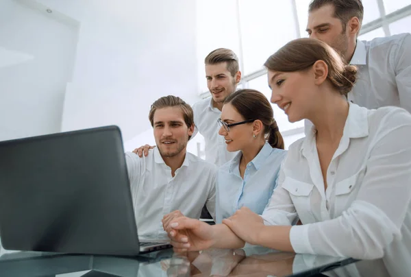 stock image business team looks at the laptop screen