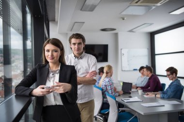 Ofis binasının penceresinden cep telefonu kullanan zarif kadın.