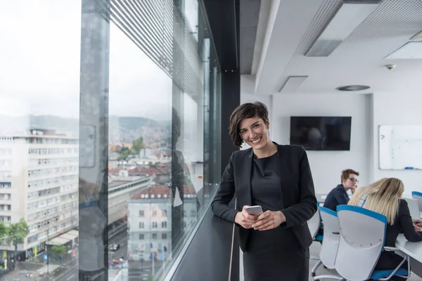 Elegant Woman Using Mobile Phone Window Office Building — Stock Photo, Image