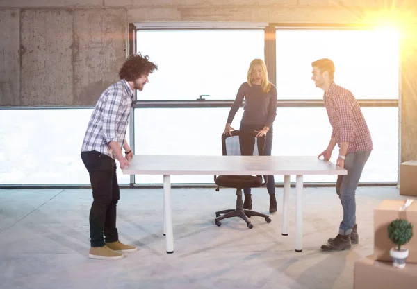 stock image business team carrying white table