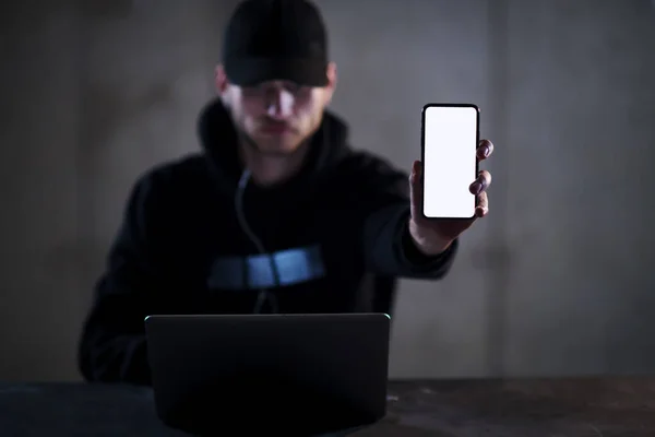 stock image criminal hacker using laptop computer while working in dark office