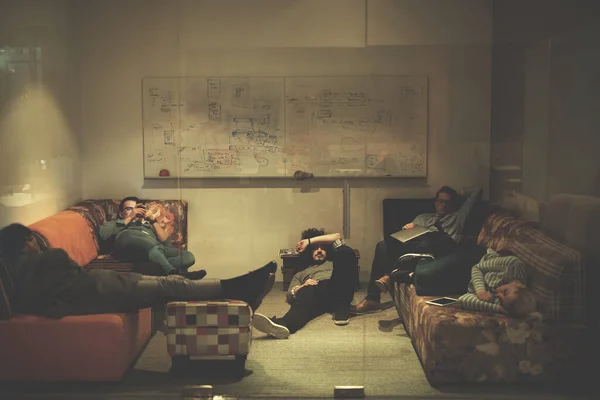 software developers sleeping on sofa in creative startup office