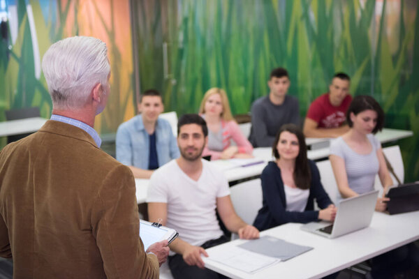 teacher with a group of students in classroom