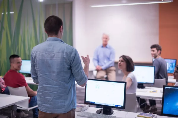 stock image student answering a question in classroom