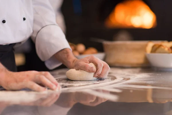 chef hands preparing dough for pizza