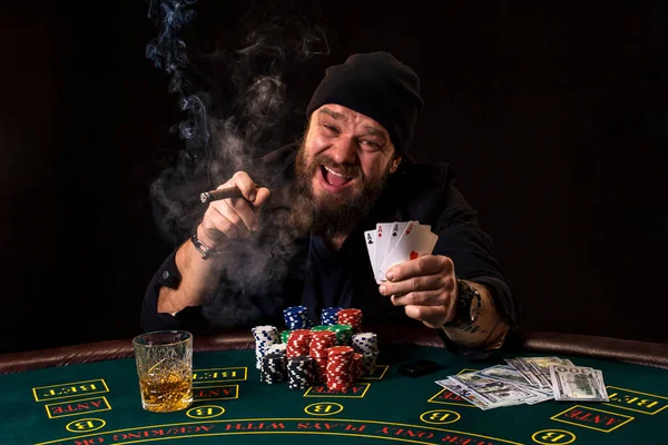 男はポーカーをプレー葉巻とウイスキー ワンマン ショー 枚のカード手に太いタバコの煙とテーブルの上のすべてのチップを獲得 — ストック写真