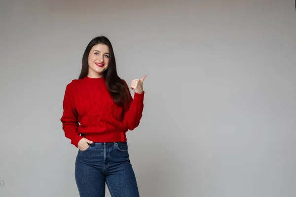 Woman Warm Red Sweater Blue Jeans Keeps Her Hand Pocket — Stok fotoğraf