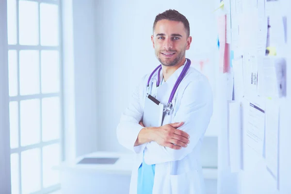 Young and confident male doctor portrait standing in medical office