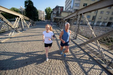 Şehirde koşan bir çift.