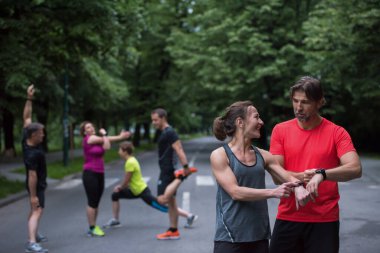 sporty couple using smart watches