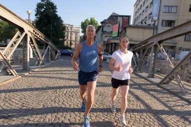 Şehirde koşan bir çift.