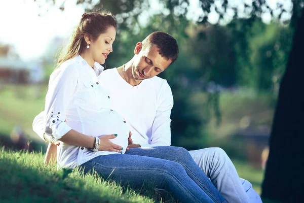 Future Parents Sitting Grass Park Sunny Day — Stock Photo, Image