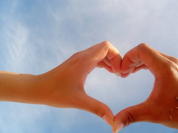Two Hands Forming Shape Heart Stock Photo