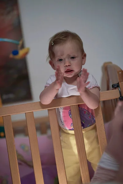 かわいい1歳の赤ちゃんとベッドで最初の一歩を踏み出す — ストック写真