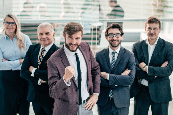 happy businessman and a group of leading experts standing together