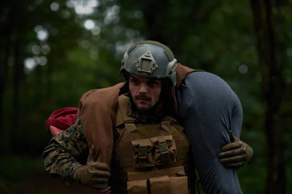 soldier rescueing civilian in forest